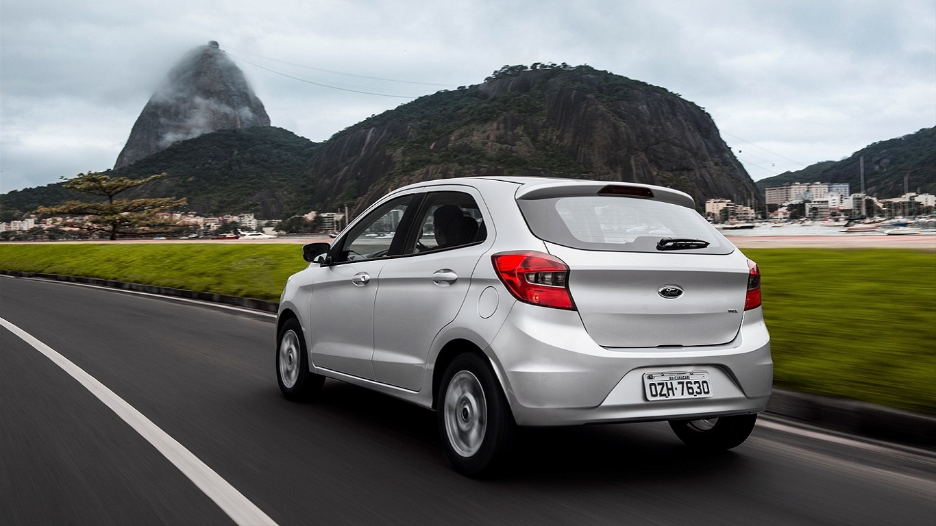 Car on highway with mountains in background